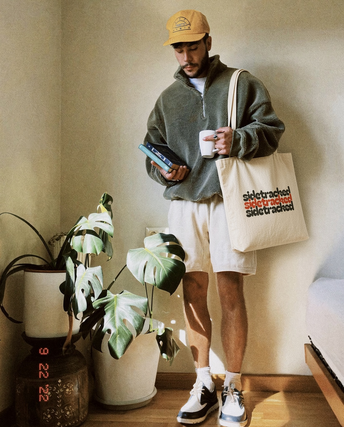 Model carrying a natural canvas Sidetracked tote bag