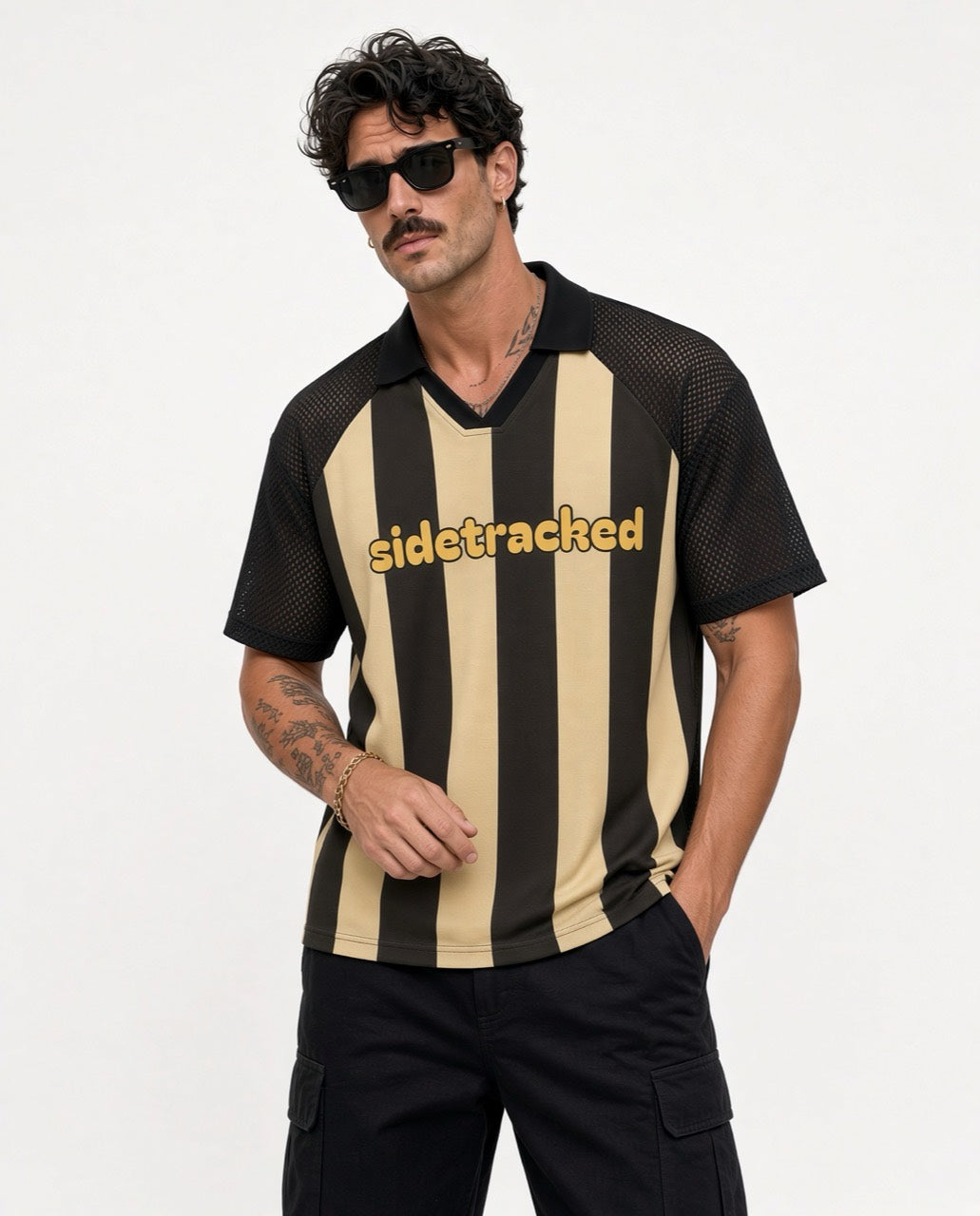 Model wearing the gold and dark striped Sidetracked soccer jersey against a light studio backdrop